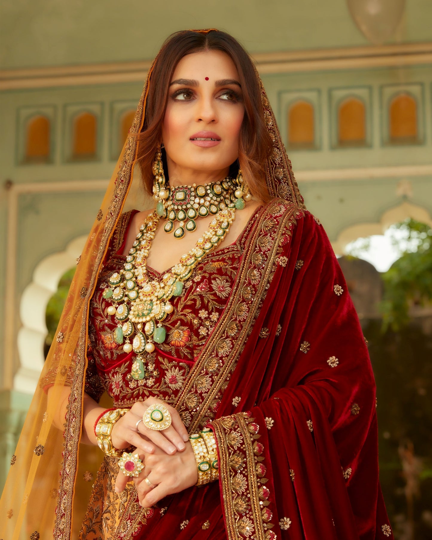 Fire Yellow Heavily Embellished Lehenga Set In Antique Work With Maroon And Green Velvet Highlights