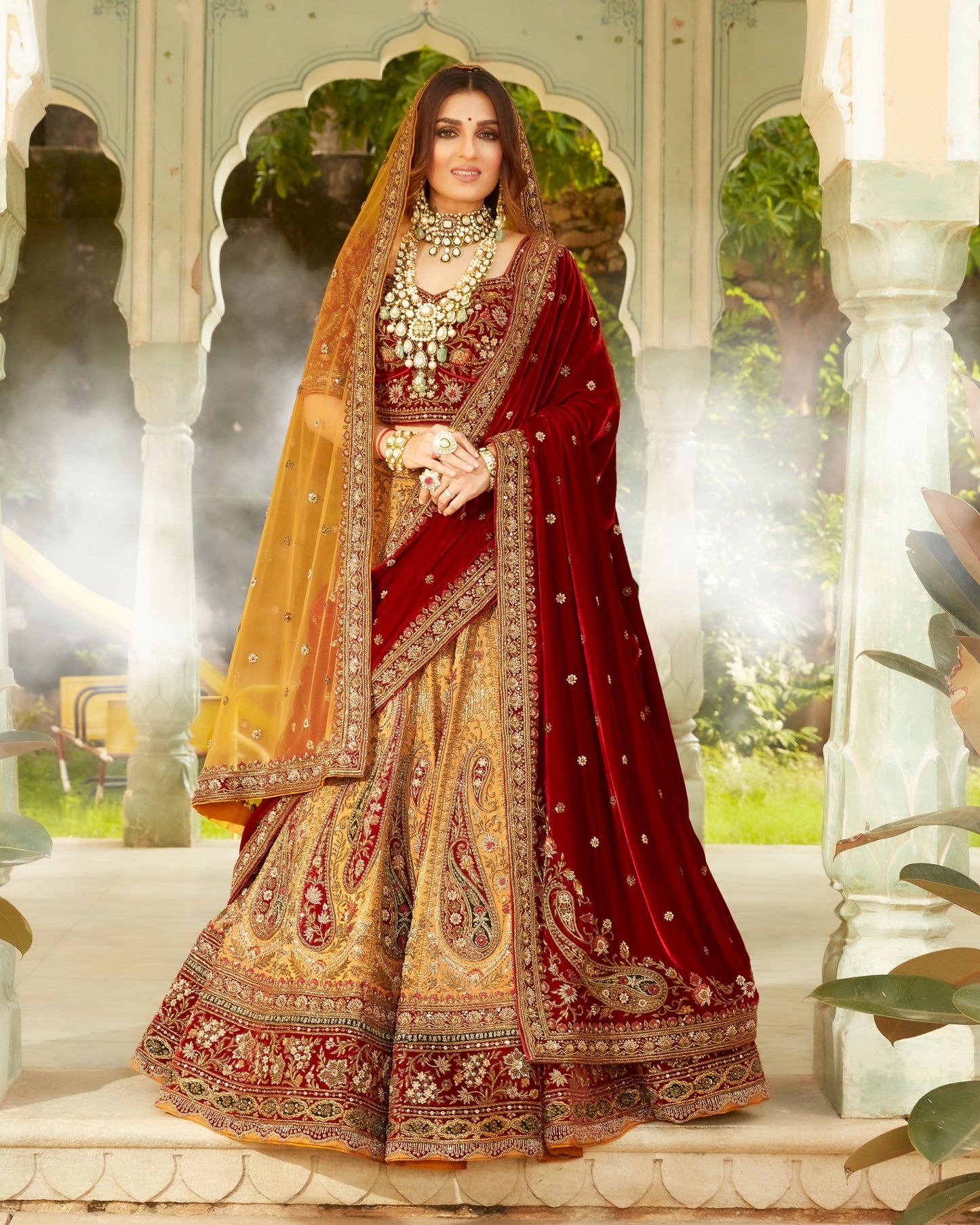 Fire Yellow Heavily Embellished Lehenga Set In Antique Work With Maroon And Green Velvet Highlights