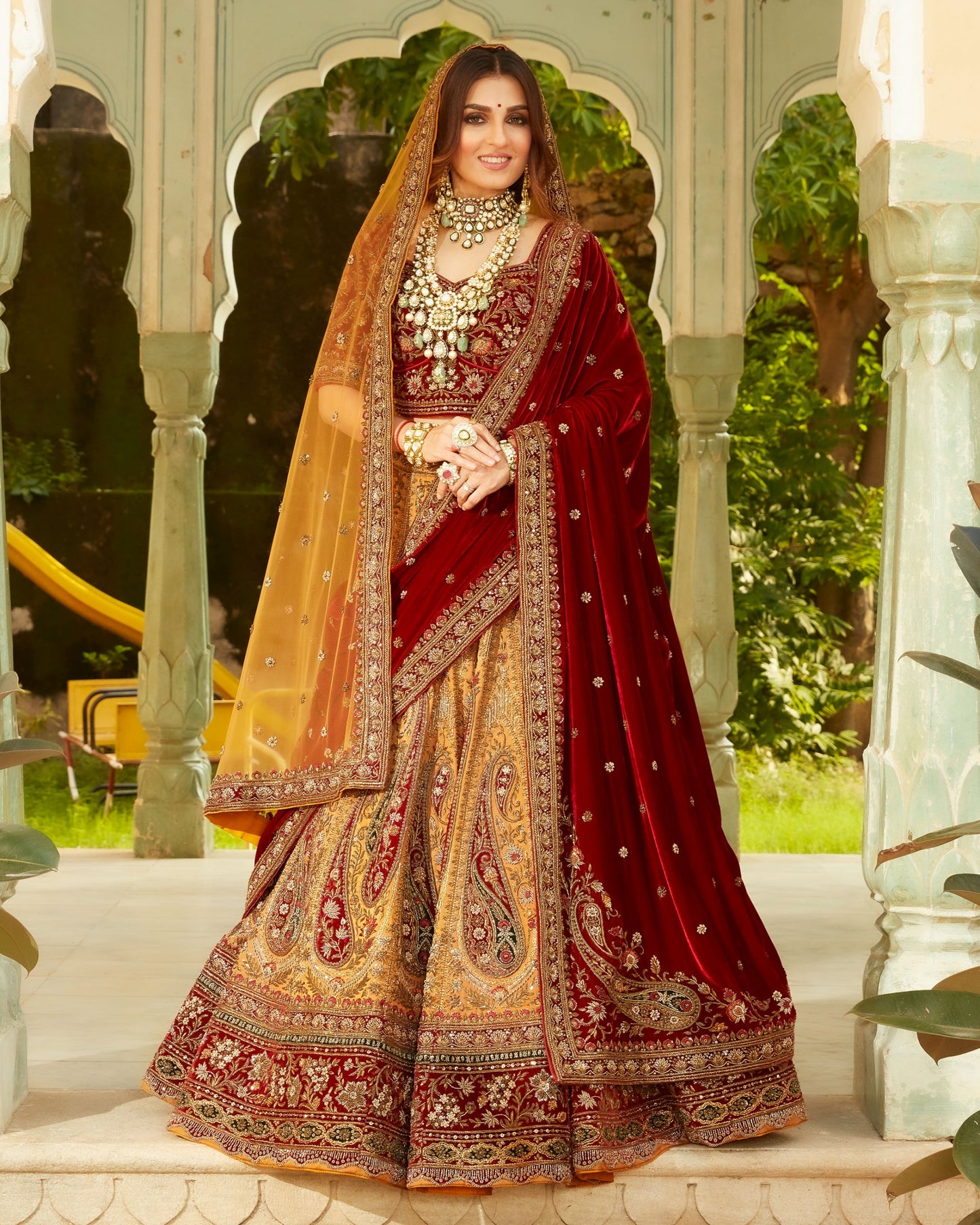 Fire Yellow Heavily Embellished Lehenga Set In Antique Work With Maroon And Green Velvet Highlights